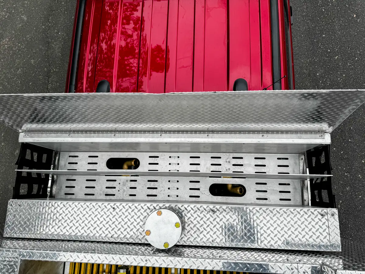 Top deck hardware close-up with reel/control mechanism and valve cap.